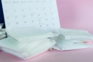 Feminine sanitary napkin on pink background photo