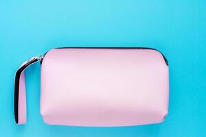 Pink lady leather bag on blue background photo