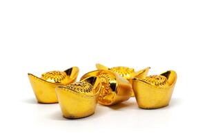 Chinese gold sycee or yuanbao boat ingot with text on top means fortune, prosperity and happiness on white background photo