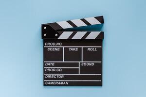 Movie clapper board on blue background photo