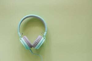 Headphones on green background photo