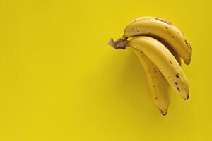 Bunch of bananas on yellow background photo