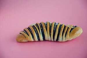Delicious bread on pink background photo