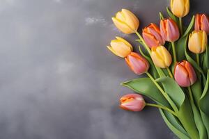 AI generated Colorful tulip flowers on dark concrete background, spring flat lay composition. Valentine's, womens, mothers day, birthday or wedding concept. Top view. Copy space. Generated AI. photo