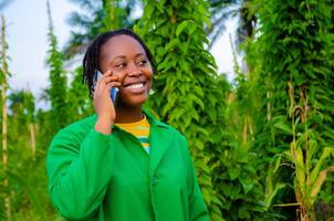 beautiful african lady making calls in the farm photo