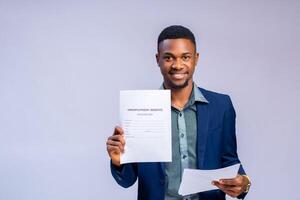 handsome african businessman holding a benefit form and smiling photo