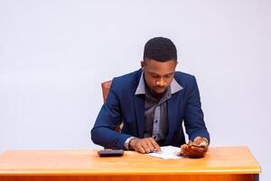 handsome african businessman going through the budget in the office photo