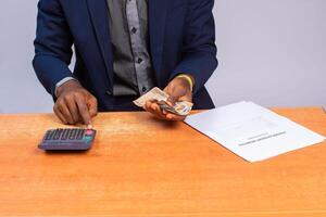 close up a business man counting and calculating money photo