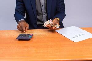 close up a business man counting and calculating money photo