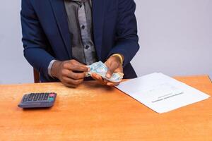 close up a business man counting and calculating money photo