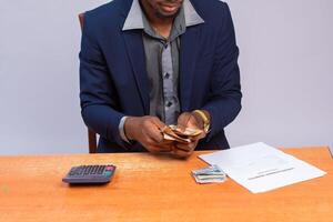 hombre contando el dinero en su mano mientras en oficina foto