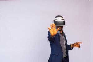 handsome man playing video games in vr goggles or 3d glasses, wearing virtual reality headset device photo