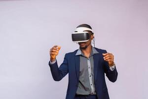 handsome man playing video games in vr goggles or 3d glasses, wearing virtual reality headset device photo