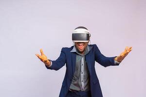 Amazed young man playing video games in VR goggles or 3d glasses, wearing virtual reality headset for on his head photo