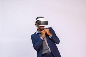 Afraid young man playing video games in VR goggles or 3d glasses, wearing virtual reality headset for on his head photo