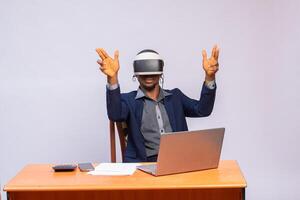 young businessman using vr headset and touching something with finger photo