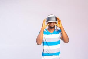 Young man using vr headset, experiencing virtual reality photo