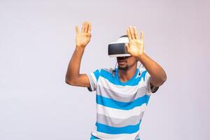 Young african american man playing virtual reality game using goggles photo