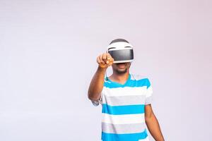 Amazed excited young african american man, wearing high tech smart vr goggles, watching 360 degree video photo