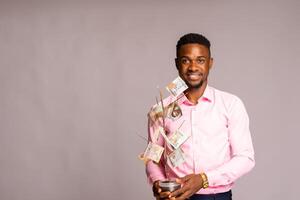 happy african man isolated over white background smiling he holds a investment tree photo