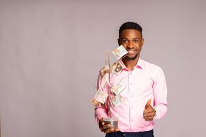 happy african man isolated over white background smiling he holds a investment tree and did thumbs up photo