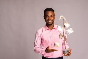 handsome man pointing to the money tree on his hand photo