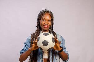 Portrait of confident female goalie holding ball photo