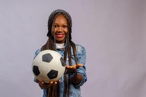 overexcited Athletic girl isolated over white background holding a soccer ball photo