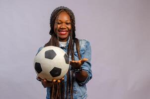 pretty african lady holding a football photo