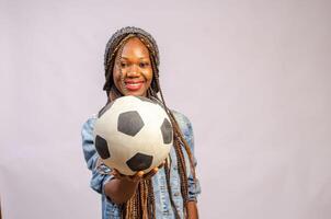 african lady holding a ball smiling photo