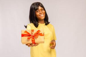 beautiful lady smiling as she holds a gift box photo