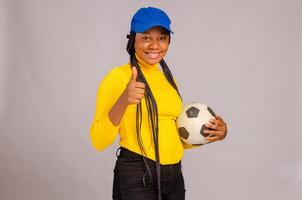 young football holding ball and did thumbs up photo