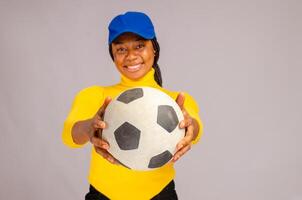 lady isolated over white background pointing out the ball she is holding photo