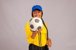 beautiful football fan smiling as she held ball on her phone photo