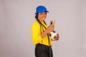 Young beautiful lady making sport bets online using mobile application. photo