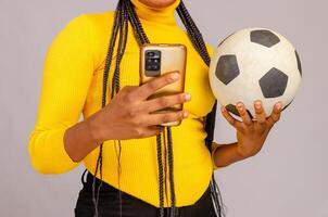 beautiful football fan holding his phone and checking scores online. photo