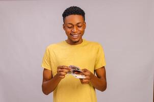 african young man counting his win from a bet photo