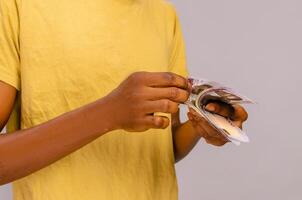 close-up of a african boy counting money photo