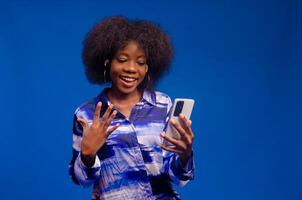 beautiful african lady feeling excited about what she saw on her phone photo