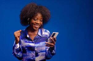 overexcited lady looking at her phone smiling photo