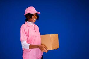 pretty african delivery worker holding a box photo