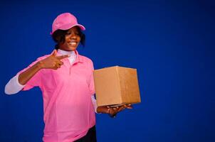 beautiful african delivery woman holding a package photo