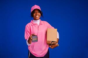 delivery worker holding a point of sale device photo