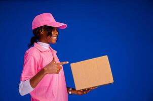 beautiful african delivery woman holding a package photo