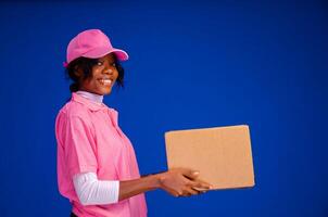 beautiful african delivery woman holding a package photo