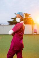 Young black female healthcare worker smiling outside, portrait photo