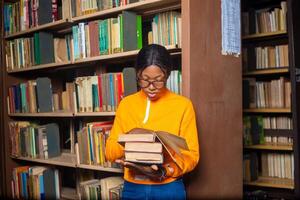 beautiful lady in the library studying her project. photo