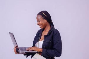 lady smiling as she hold her laptop isolated over white photo