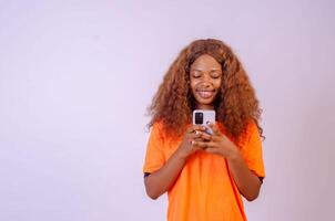 young black woman using her phone and smiling photo