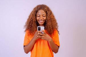 young black woman using her phone and smiling photo